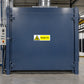 Warning sticker reading Danger hot on blue industrial equipment panel