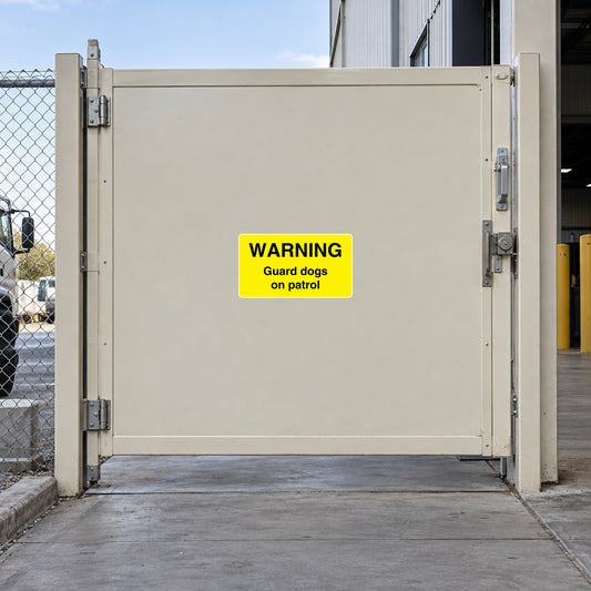 Yellow warning sticker: WARNING, Guard dogs on patrol