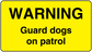 Yellow warning sticker reading 'WARNING' and 'Guard dogs on patrol'