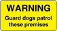 Warning guard dog premises sticker, yellow with black text: WARNING Guard dogs patrol these premises