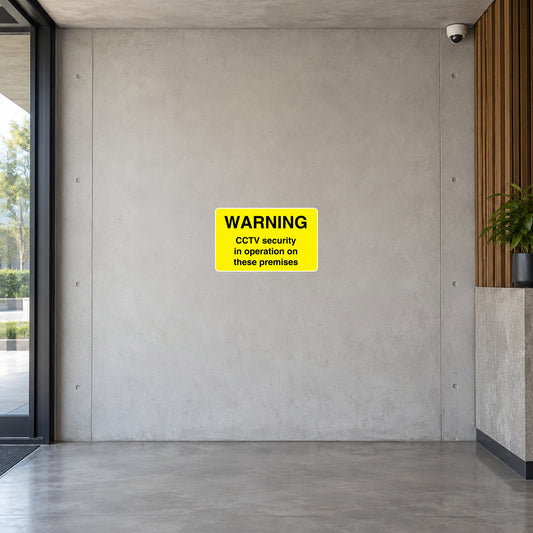 CCTV security warning sticker with yellow background and black 'WARNING' and 'in operation' text
