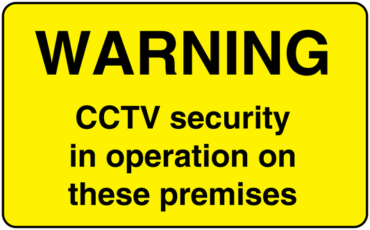 Yellow CCTV warning sticker with black text: WARNING CCTV security in operation on these premises