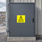Warning danger 6600 volts sticker on metal door panel, yellow with black text and bolt icon