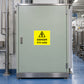 Yellow warning sticker with black triangle and text 'DANGER 415 volts'