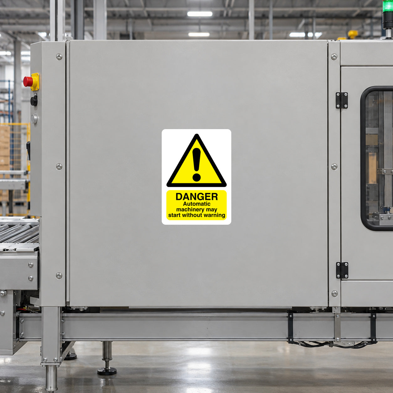 Danger Automatic Machinery Sticker applied in Broad smooth light-gray guarded automatic conveyor enclosure panel in a fulfillment center, central face clear, controls and closed inspection window only far sides.