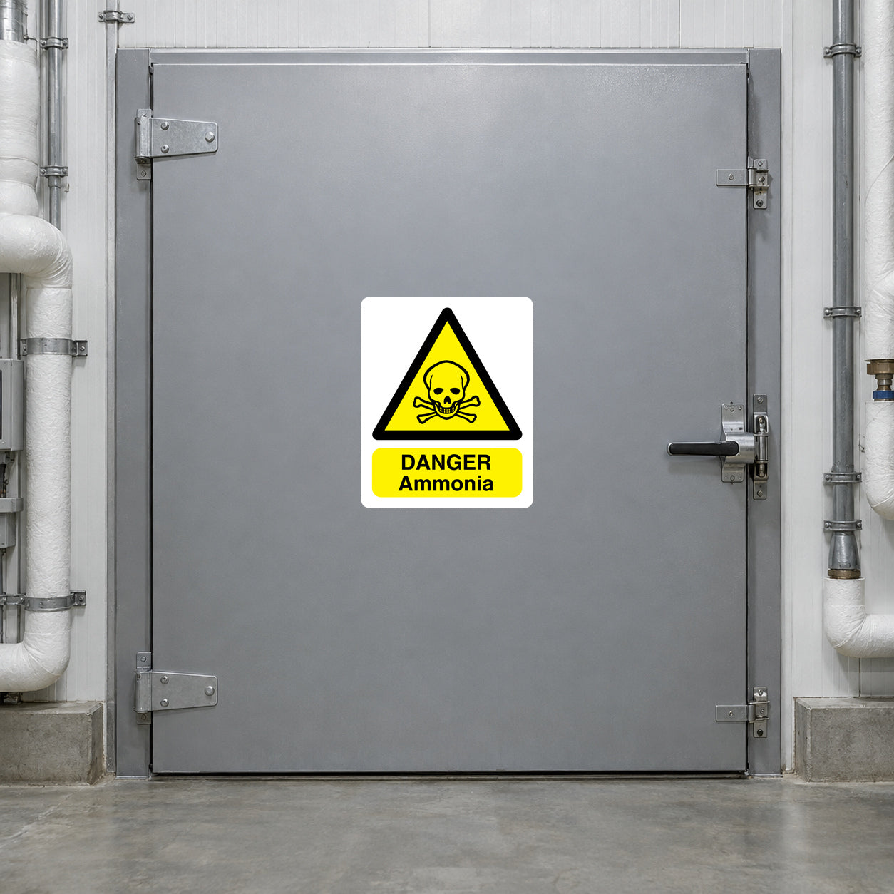 Danger Ammonia Poison Sticker applied in Closed broad gray ammonia refrigeration access door in a refrigerated food warehouse, opaque central face clear, lever far right, insulated pipes only margins.