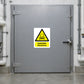 Danger Ammonia Poison Sticker applied in Closed broad gray ammonia refrigeration access door in a refrigerated food warehouse, opaque central face clear, lever far right, insulated pipes only margins.