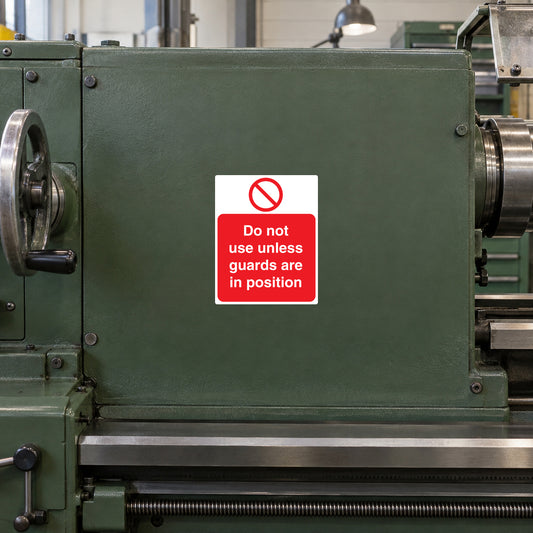 Green machine guard with red warning sticker: do not use unless guards in position