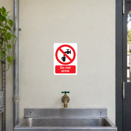 White square warning sticker: red no symbol with glass, text 'Do not drink'.