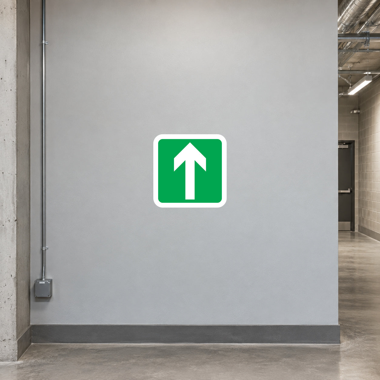 Left Arrow Sticker applied in warehouse straight emergency escape corridor, smooth light grey wall, clear onward passage glimpsed at edge
