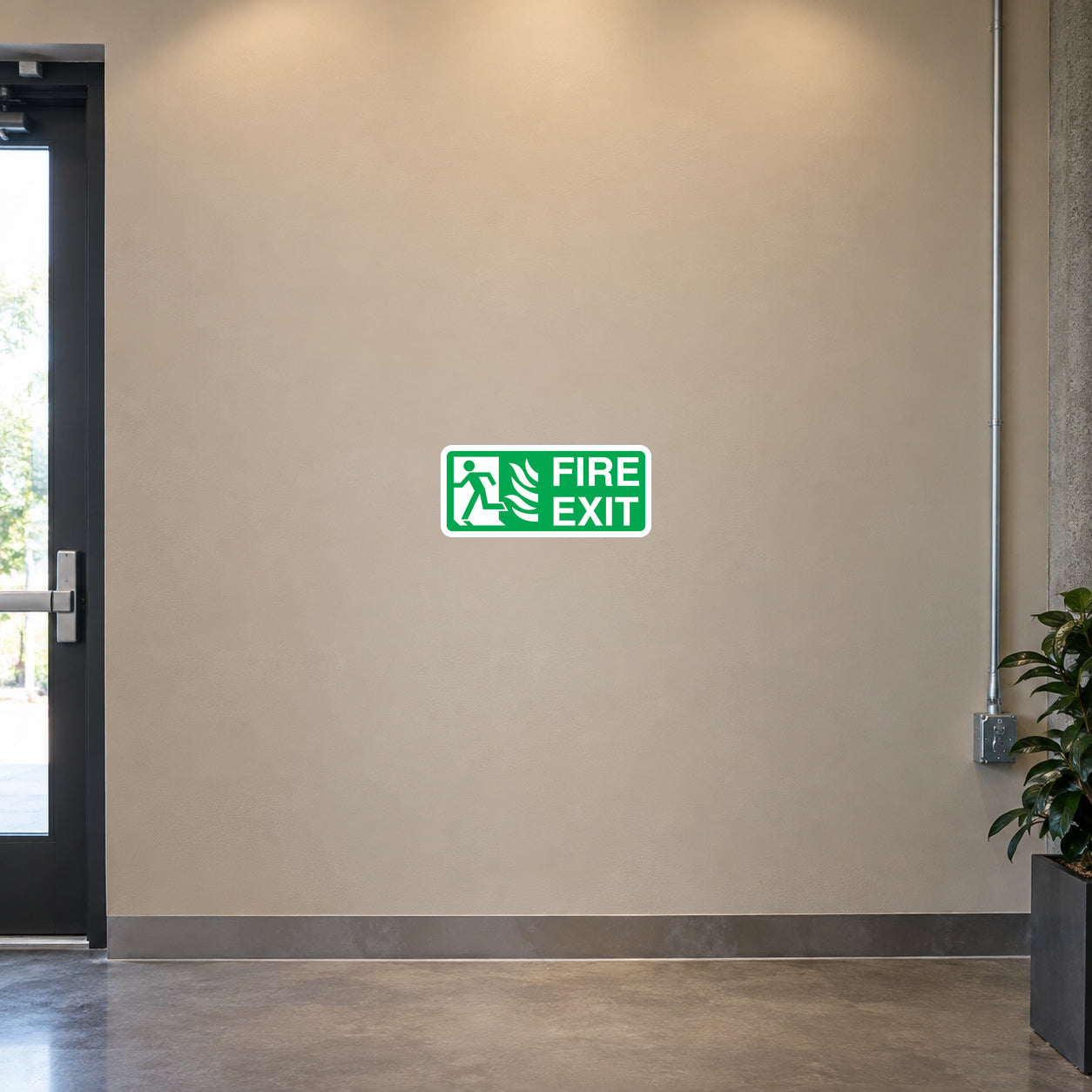 Fire exit here safety sticker with green running person and arrow icon