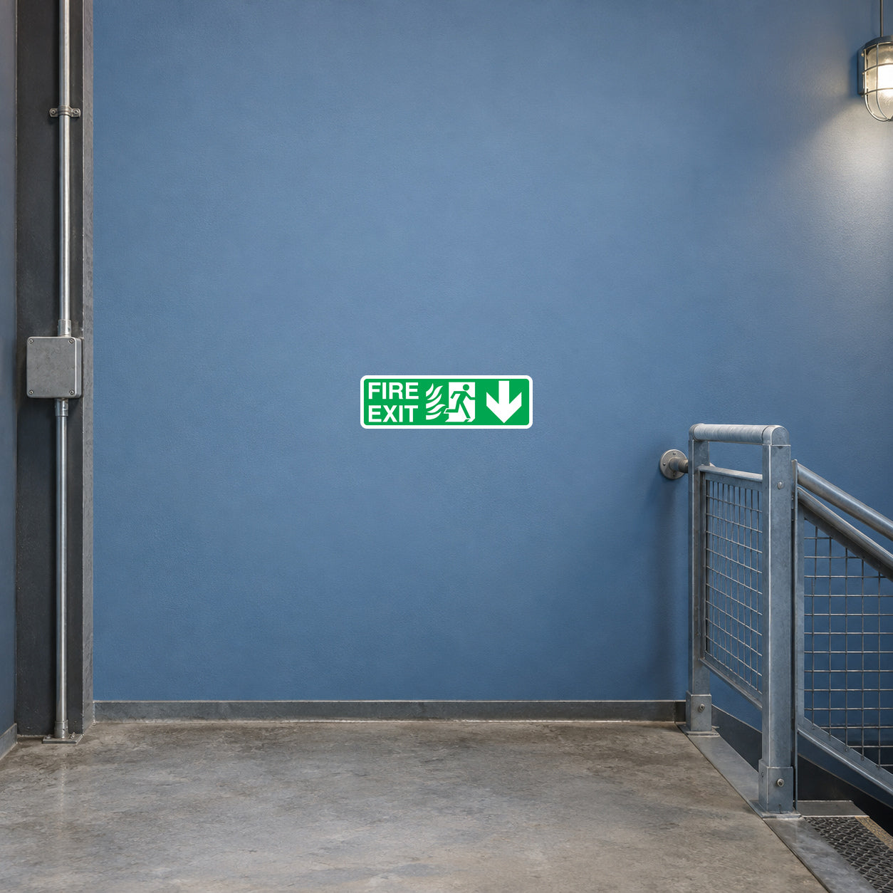 Green fire exit sign sticker with running figure and downward arrow