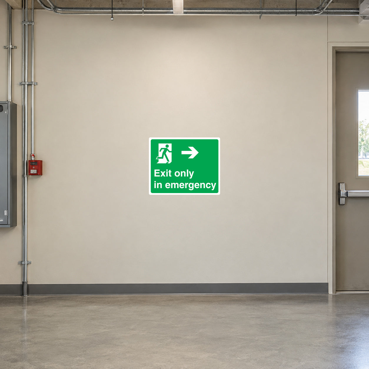 Exit Only In Emergency Safety Sign Sticker applied in secured factory emergency escape corridor, smooth cream wall, emergency exit at extreme right, unobstructed floor
