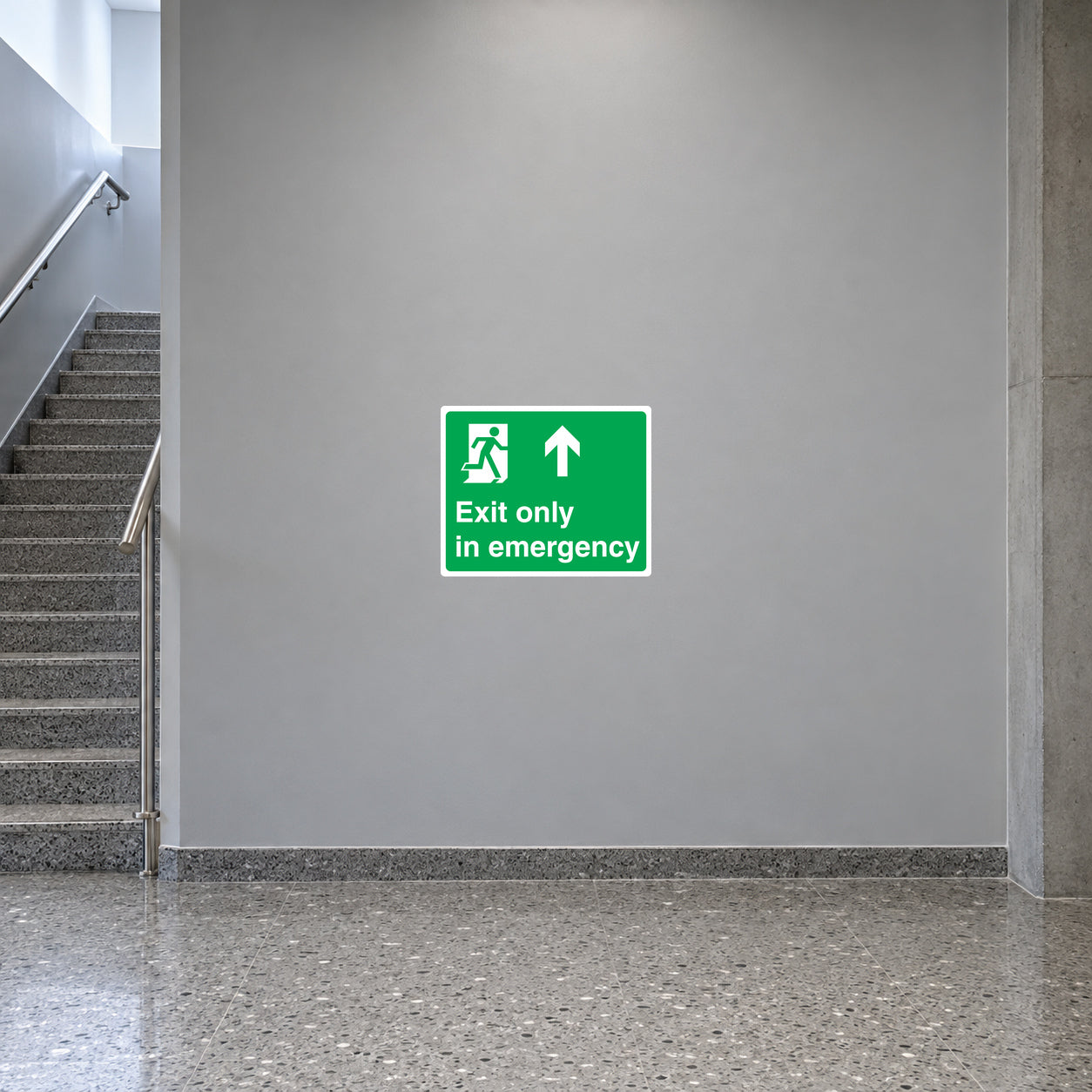 Green emergency exit sticker with running icon, up arrow, and text 'Exit only in emergency'.