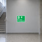 Green emergency exit sticker with running icon, up arrow, and text 'Exit only in emergency'.