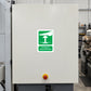 Emergency stop push-button sticker with green icon on white square panel