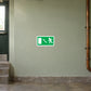 Emergency exit door sticker with green sign and directional arrow icon