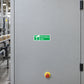 Emergency stop safety sticker: green sign with white icon and Emergency stop text