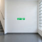 Emergency stairs up safety sticker, green sign with white arrow and running figure