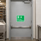 Exit Only In Emergency wall sticker, green sign with running person and arrow icons