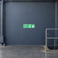 Green fire exit down sticker with running figure and arrow