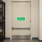 Green fire exit keep clear sticker on a door, white text on green sign