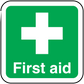 Green first aid sticker with white cross and “First aid” text