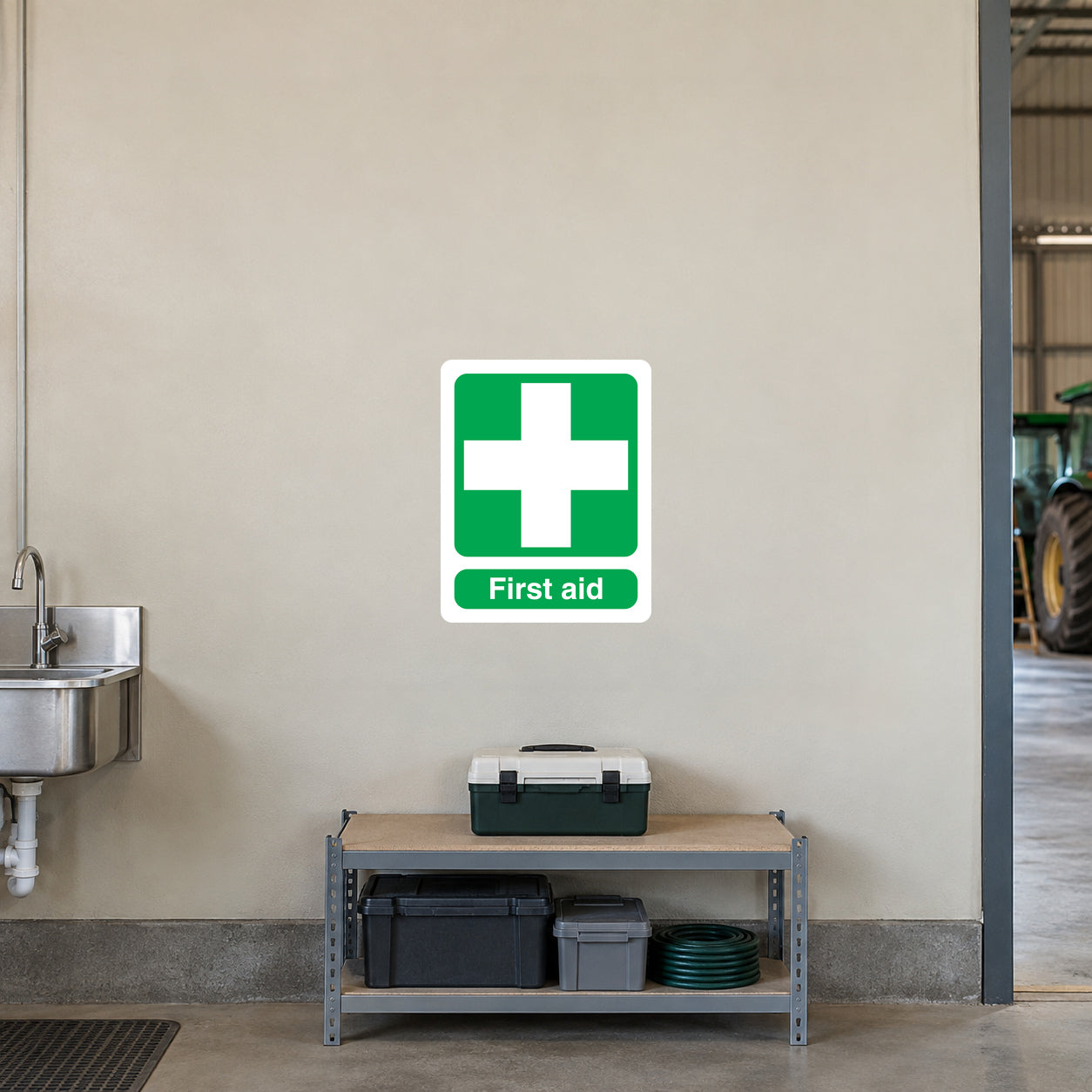 First aid sticker with green cross and “First aid” text on white background