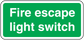 Green light switch sticker with white text “Fire escape light switch”
