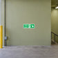 Green emergency fire exit sticker with running figure and right-down arrow