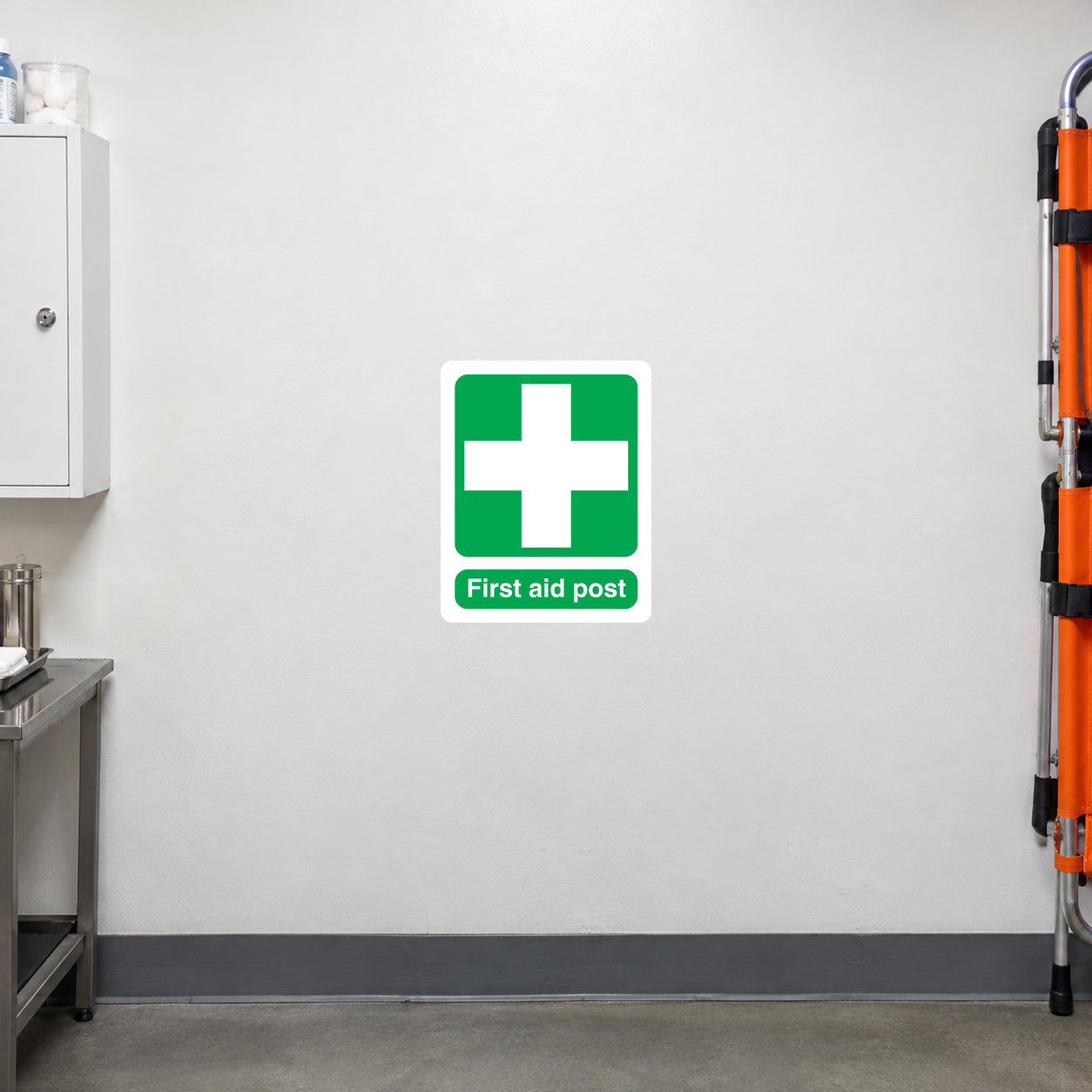 First aid post sticker with green medical cross icon and label text