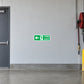 Green fire exit direction sticker with running figure, left arrow, FIRE EXIT text