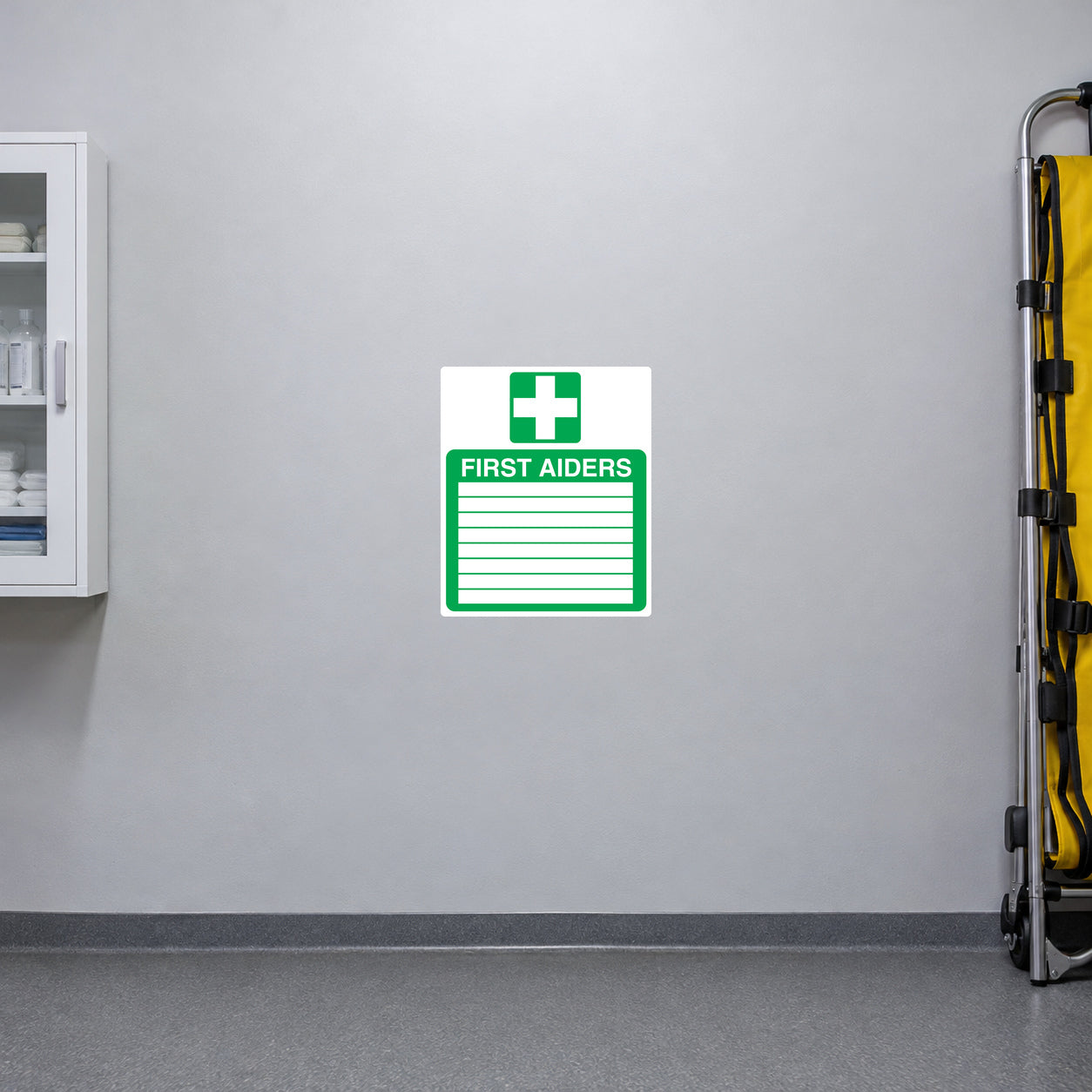 First Aiders sticker with green cross and lined first aid notice on white background