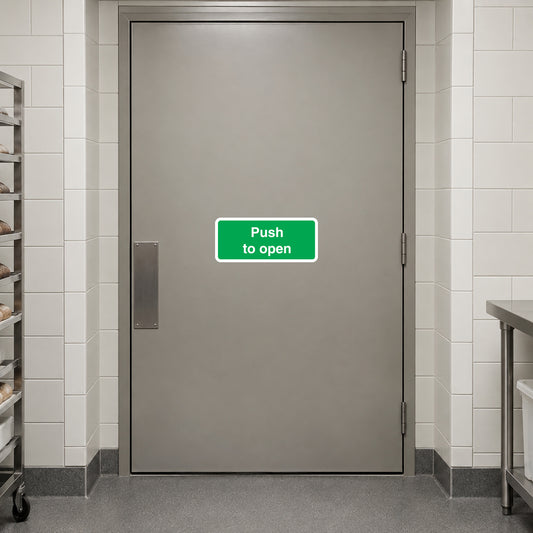 Safety sign sticker with green "Push to open" text on door surface