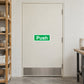 Green Push door safety sign sticker on a closed door