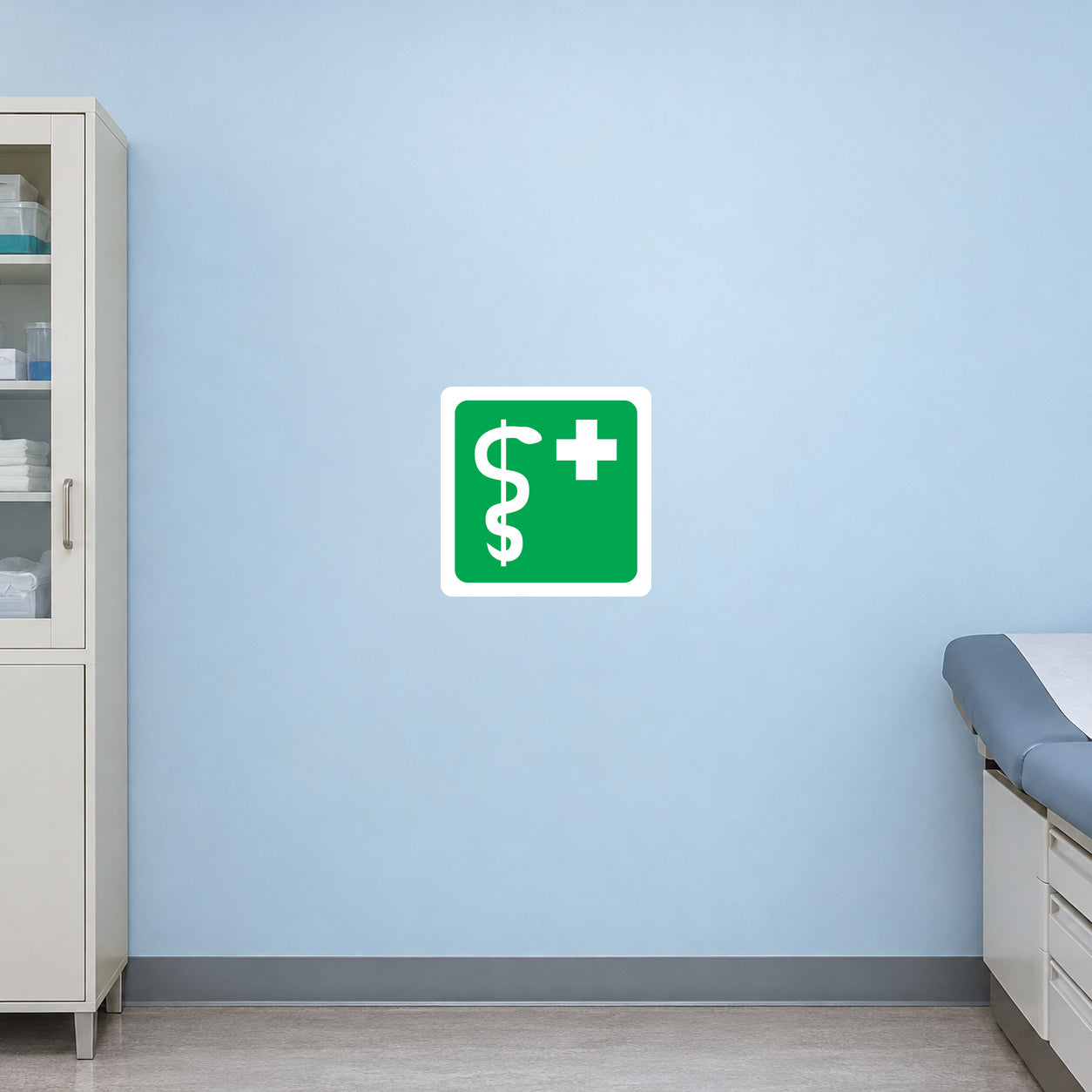 First aid sticker: green square with white cross and $ sign