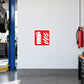 Fire extinguisher here sticker with red extinguisher and flame icon on white