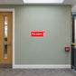 Fire alarm sticker in a university residence corridor