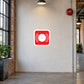 Fire alarm bell symbol sticker in a converted factory corridor