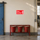 Fire Bucket sticker on a factory wall above sand-filled fire buckets