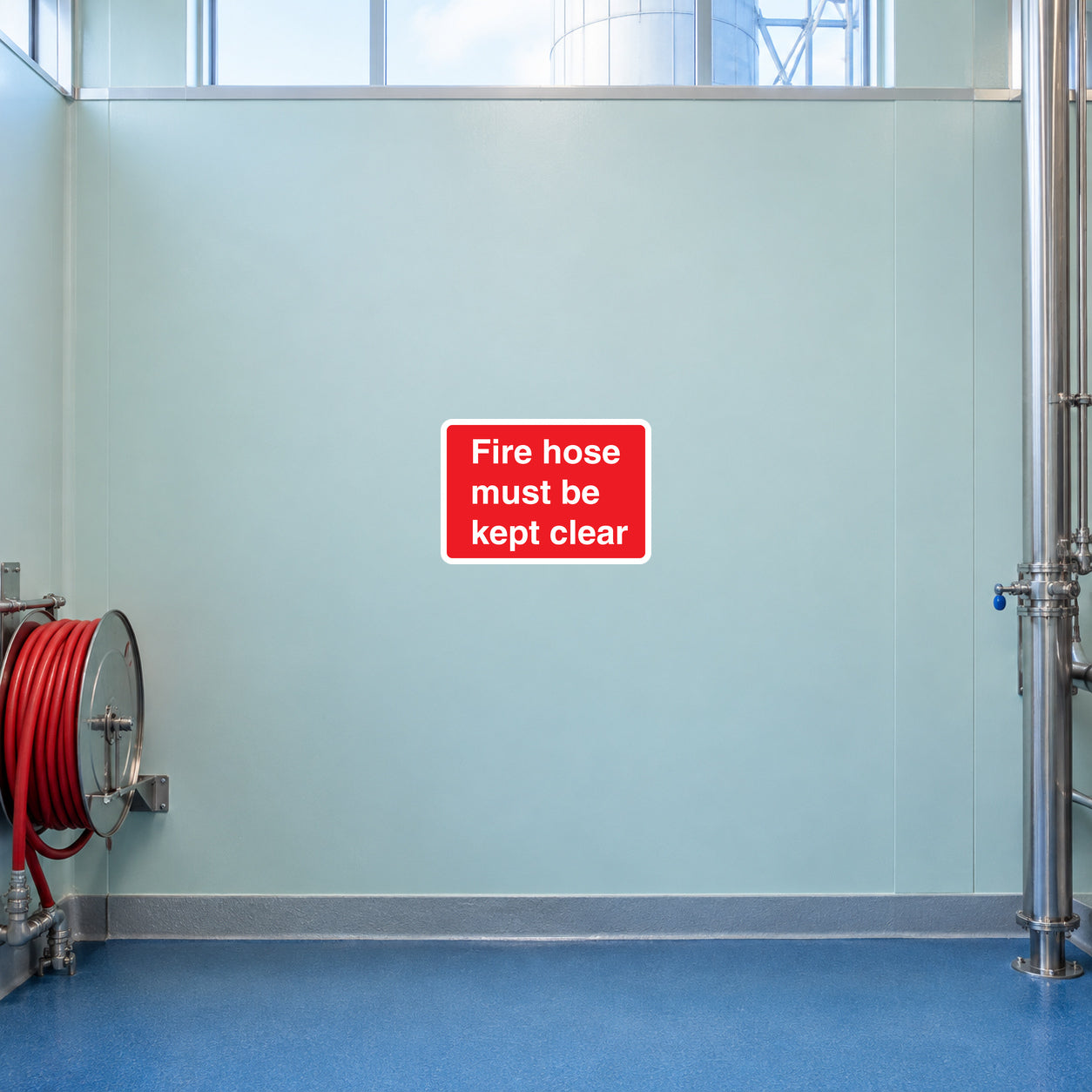 Red rectangular text sticker reading 'Fire hose must be kept clear'