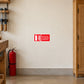 Not For Use On Electrical Equipment Sticker applied in a woodworking studio fire point, smooth cream wall, red water-type extinguisher far lower left, closed timber tool cabinet far right, sealed tan concrete floor