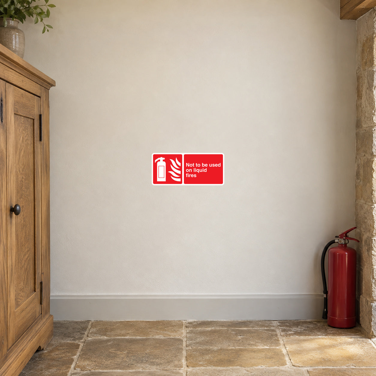 Red safety sticker with white warning text: Not to be used on liquid fires