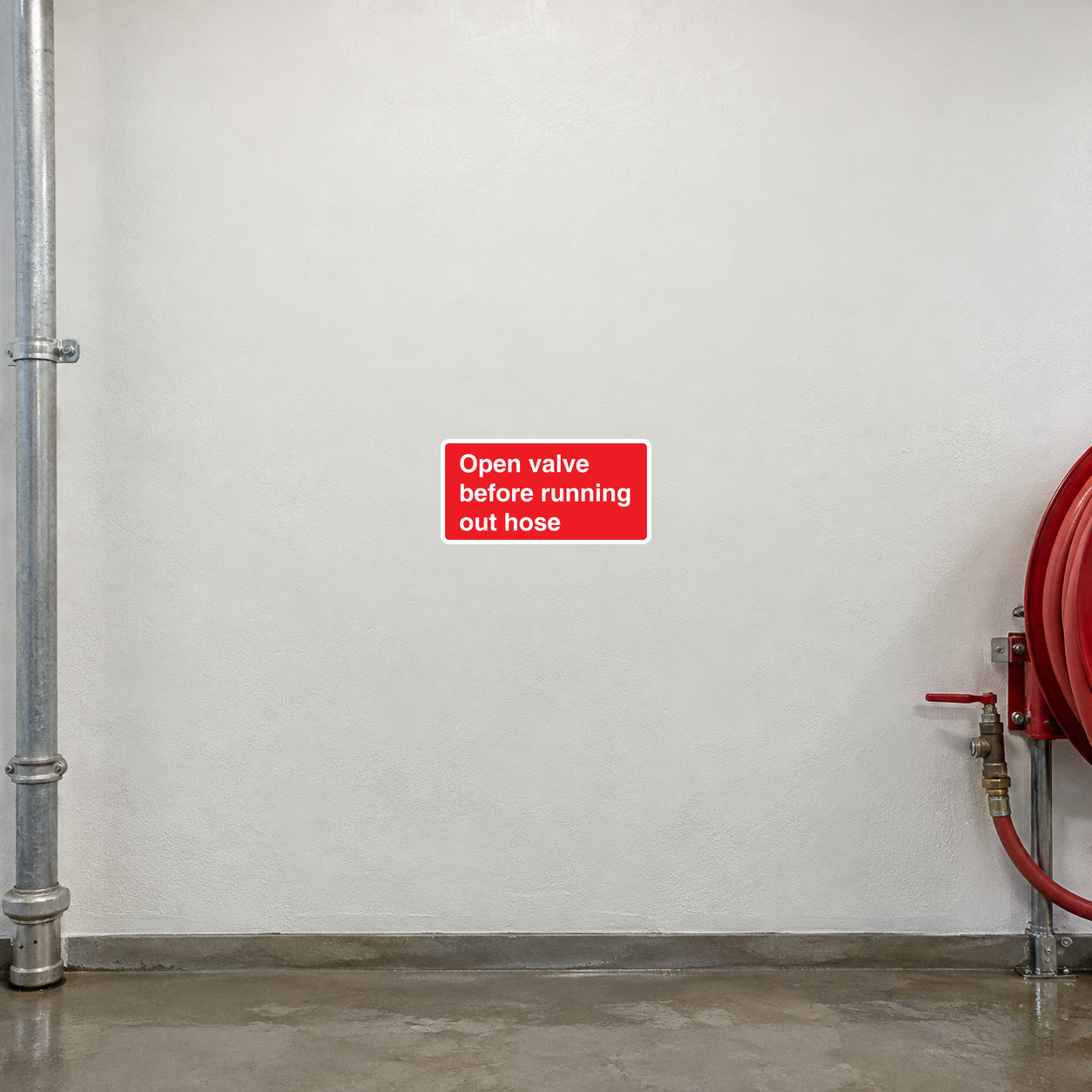 Red safety sticker with white text: Open valve before running out hose