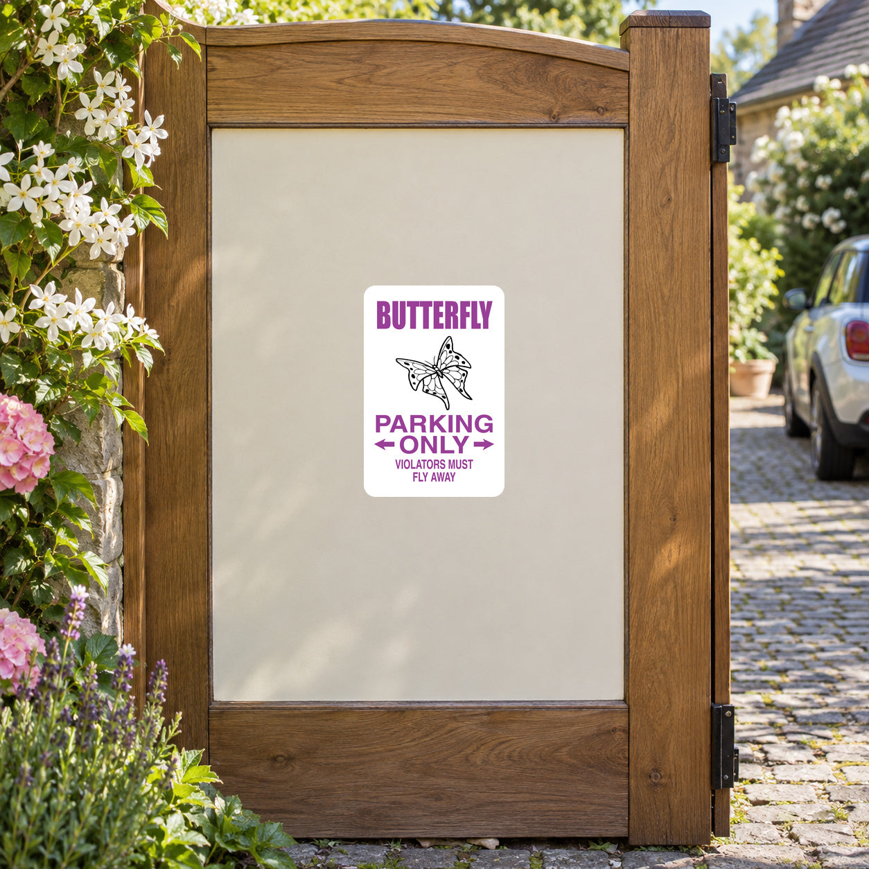Butterfly Parking Only sticker on a private garden driveway gate