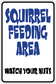 Fun sign sticker with blue squirrel feeding area text and "Watch your nuts"