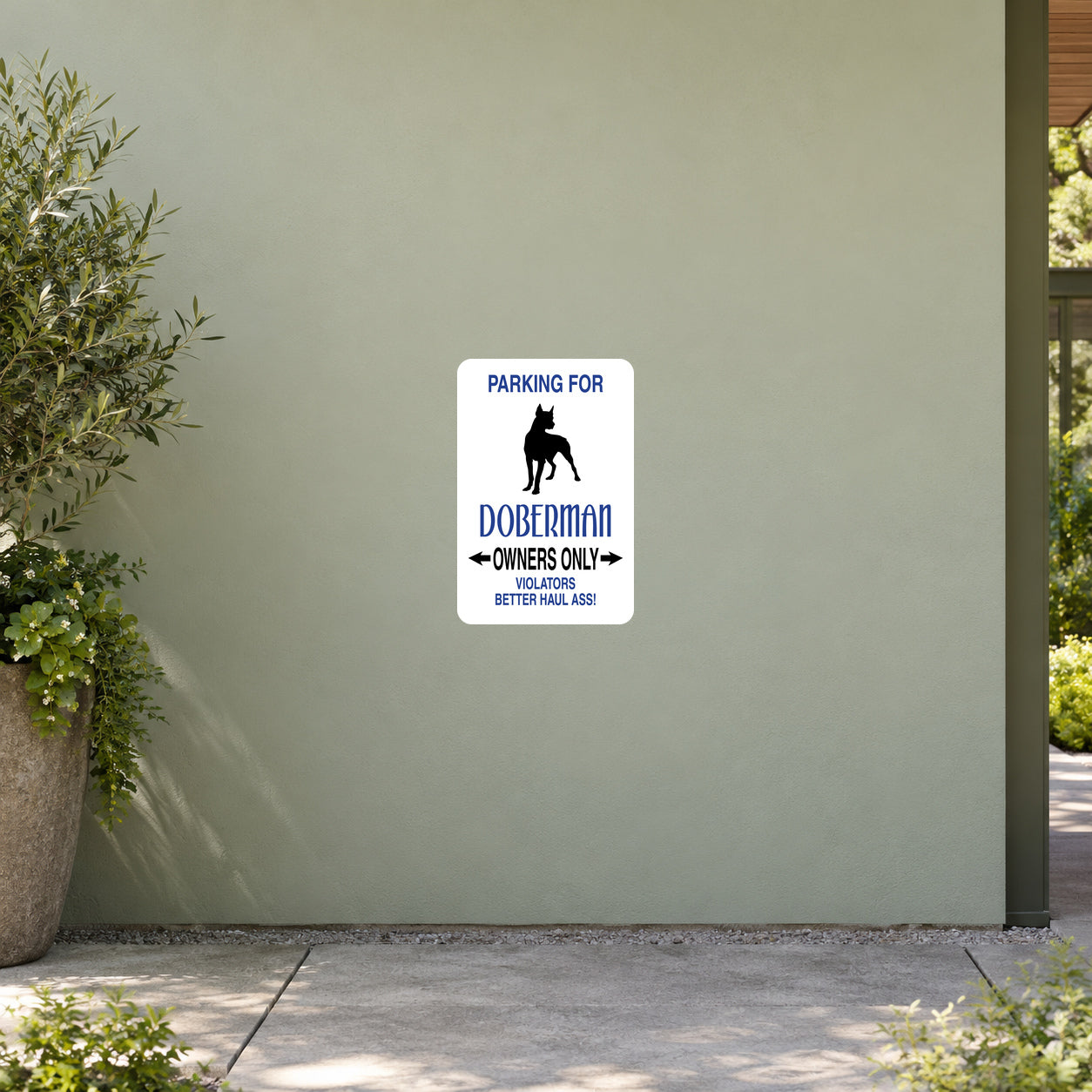 Parking For Dobberman Owners Only Fun Sign Sticker applied to a pale sage garden visitor centre wall