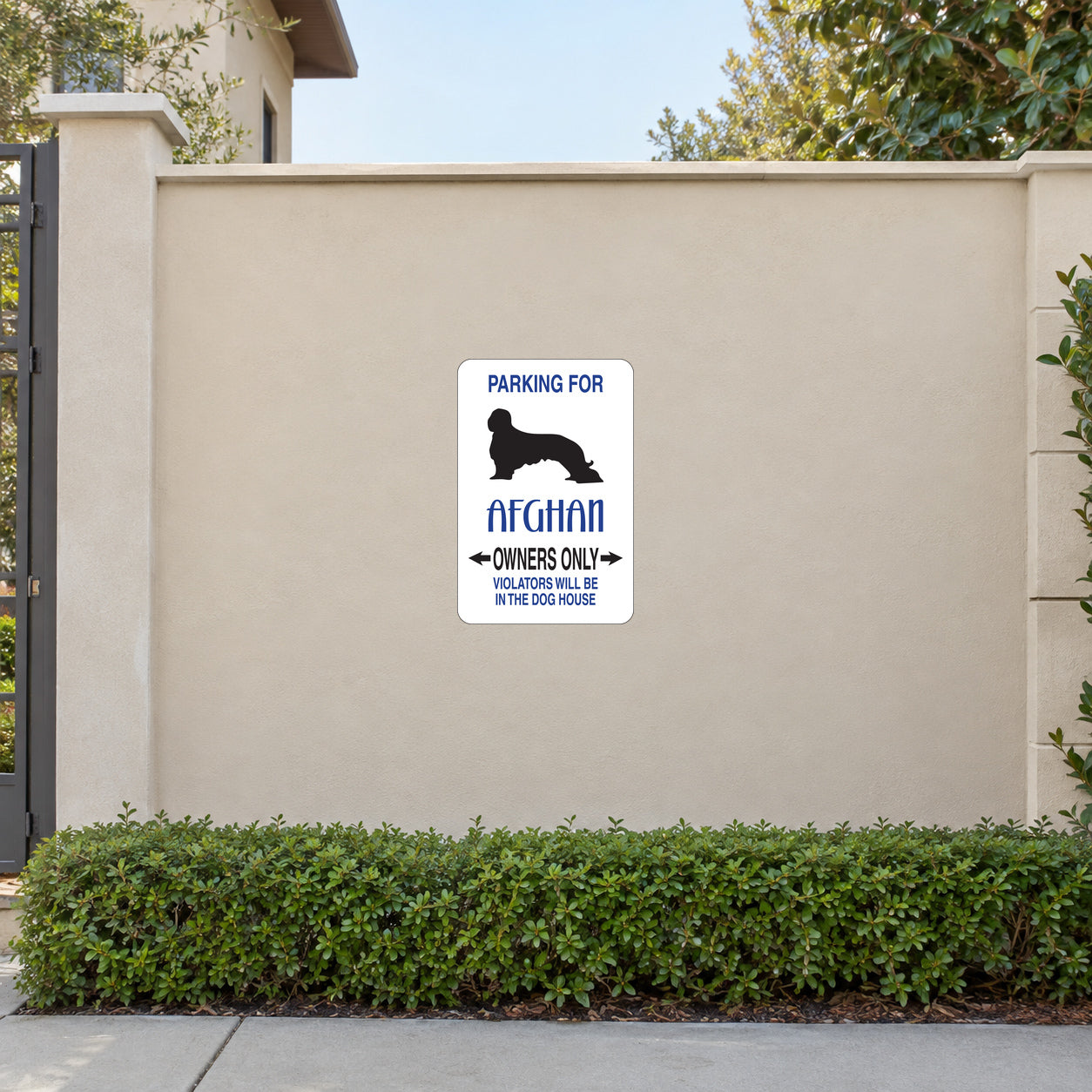 Parking For Afghan Owners Only Fun Sign Sticker applied to a beige garden boundary wall