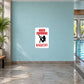 Naked Swimming Mandatory Fun Sign Sticker applied to a pale aqua indoor pool wall
