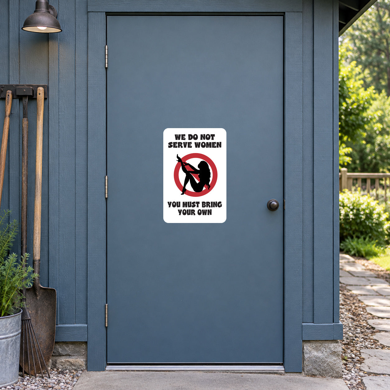 We Do Not Serve Women Fun Sign Sticker applied to a slate blue rural workshop door